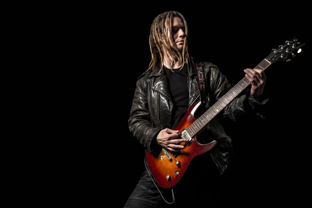 musician-playing-electric-guitar-e1648798328796.jpg