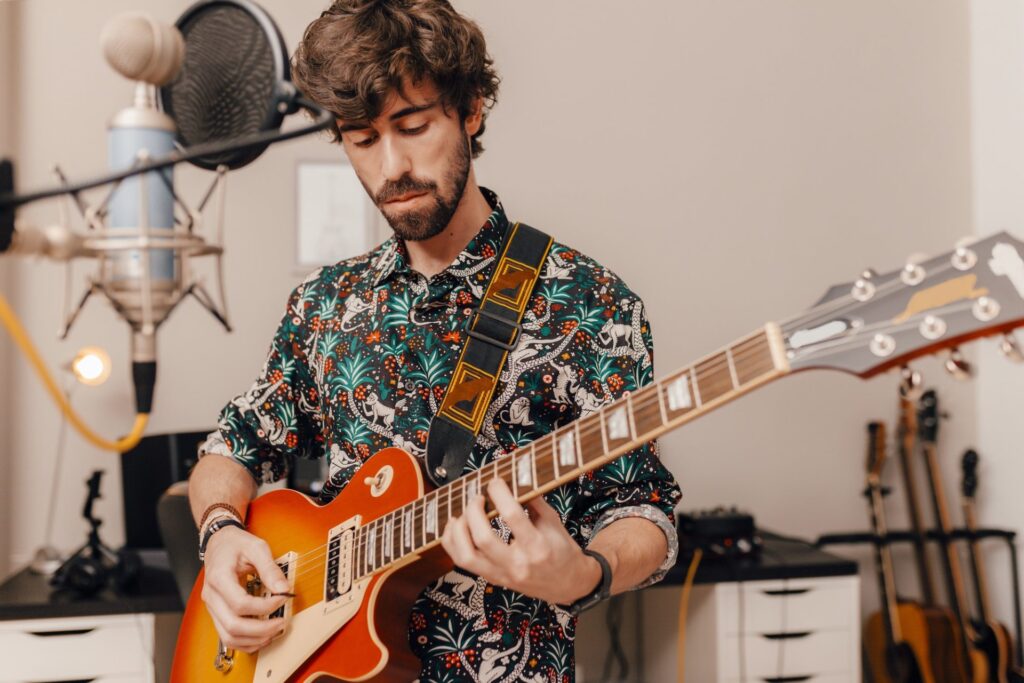 young-man-playing-an-electric-guitar-e1648798929945.jpg