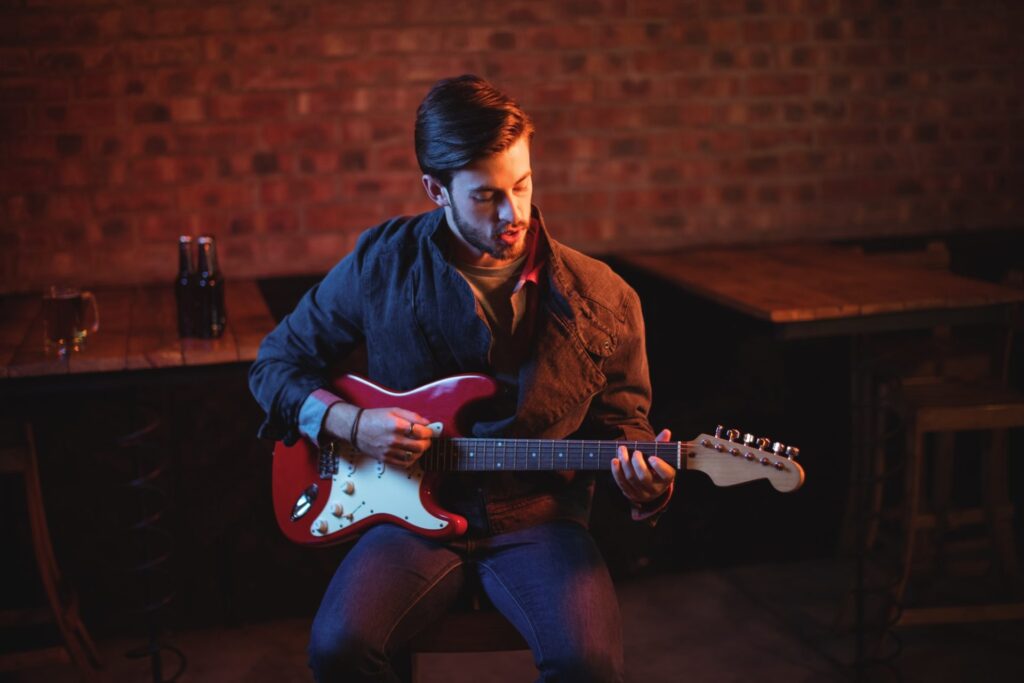 young-man-playing-guitar-e1648460846386.jpg